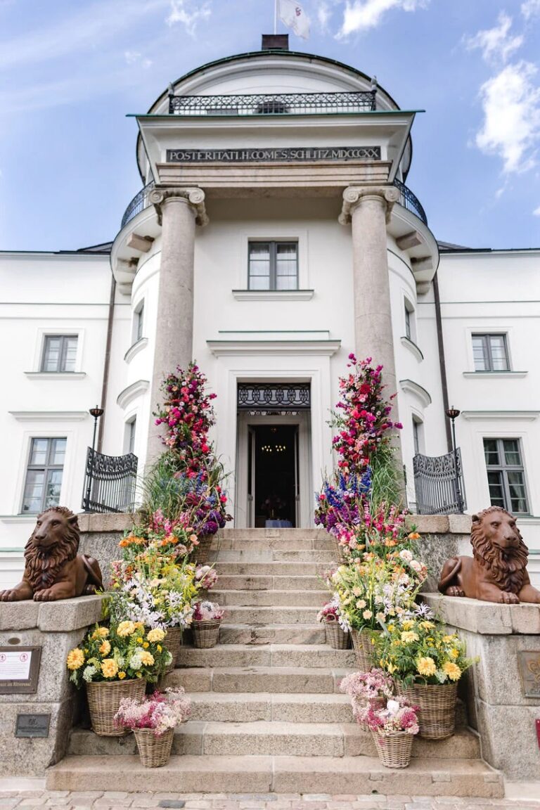 Entrance steps framed with colourful flower arrangements, High Emotion Weddings