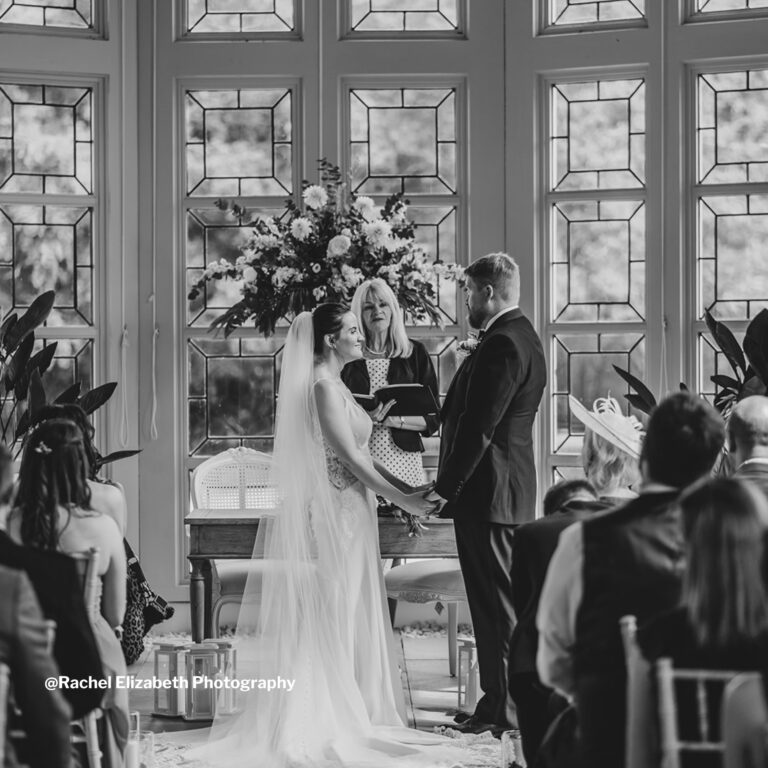 A couple exchanging vows, in black and white, Highcliffe Castle