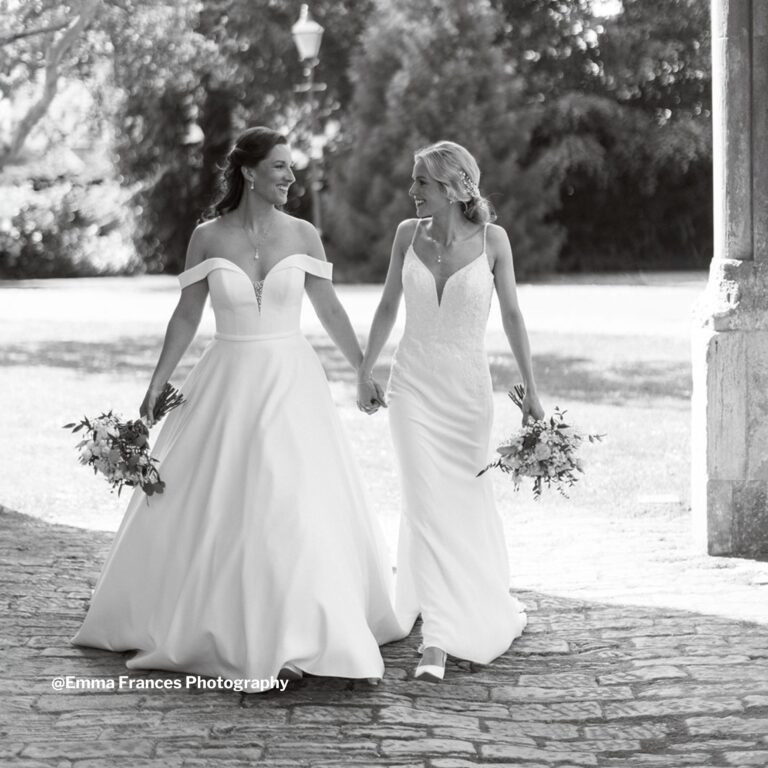 Two brides walking together, in black and white, Highcliffe Castle