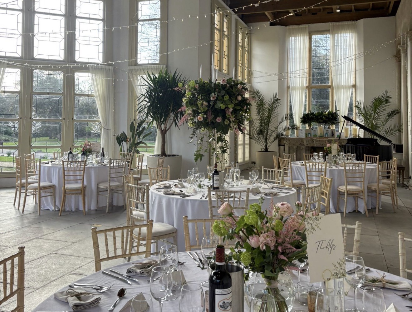 The Wintergarden laid with round tables and flowers, Highcliffe Castle