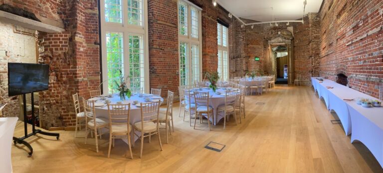 Tables laid along a brick-walled room, Highcliffe Castle