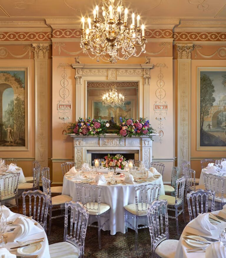 A round table beneath a chandelier in a decorated room, Home House
