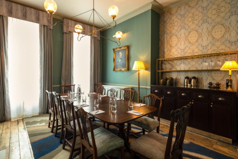 A dining room with a long table, Home House