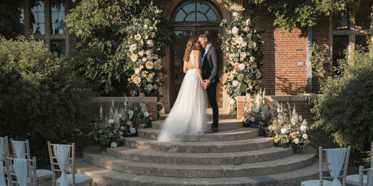 The Manor House steps dressed with flower arches and chairs for an outdoor ceremony, Horwood House Hotel & Spa