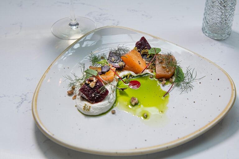 A plated starter of beetroot, smoked fish and herb oil, Horwood House Hotel & Spa