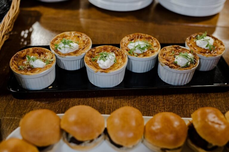 Canapes of small pies and mini brioche burgers on serving boards, Horwood House Hotel & Spa