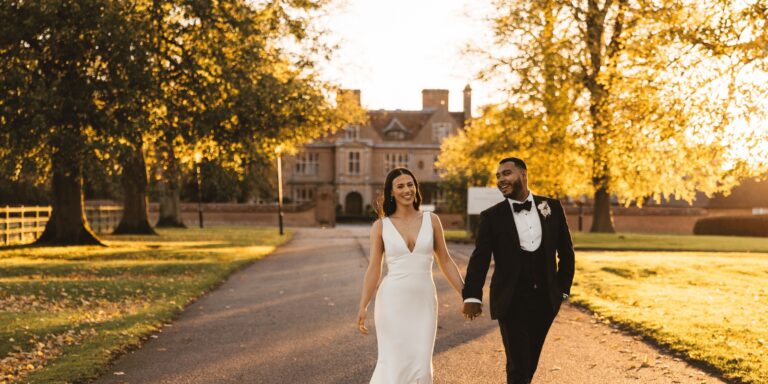 A couple walking the drive in autumn light, the Manor House entrance at the end of the avenue, Horwood House Hotel & Spa