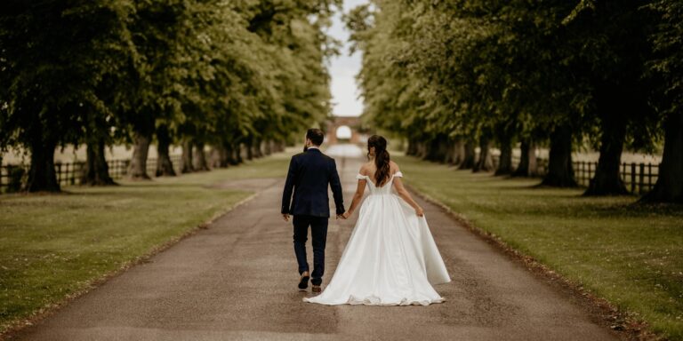 A couple walking down the tree-lined avenue that approaches the house, Horwood House Hotel & Spa
