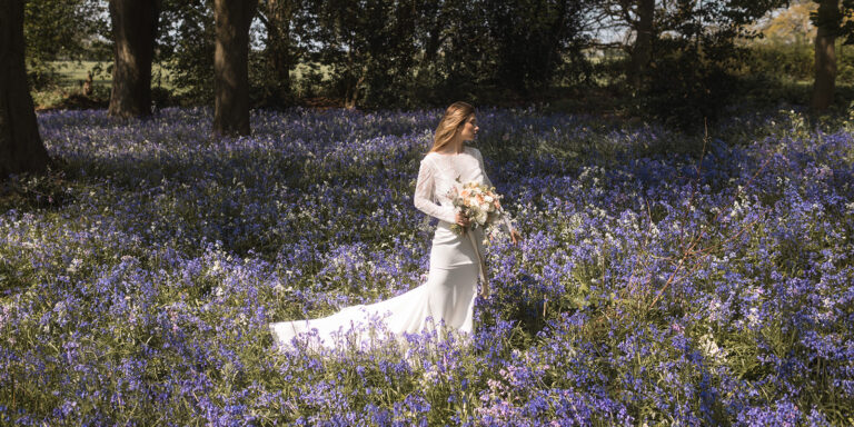A bride among bluebells in the estate woodland in spring, Horwood House Hotel & Spa