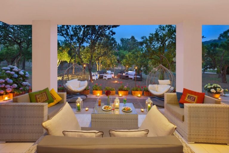 The terrace lounge at dusk, candles lit among the citrus, Hotel Alpha