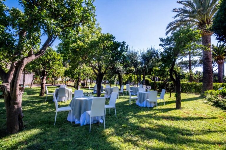 Wedding tables beneath the centuries-old citrus grove, Hotel Alpha