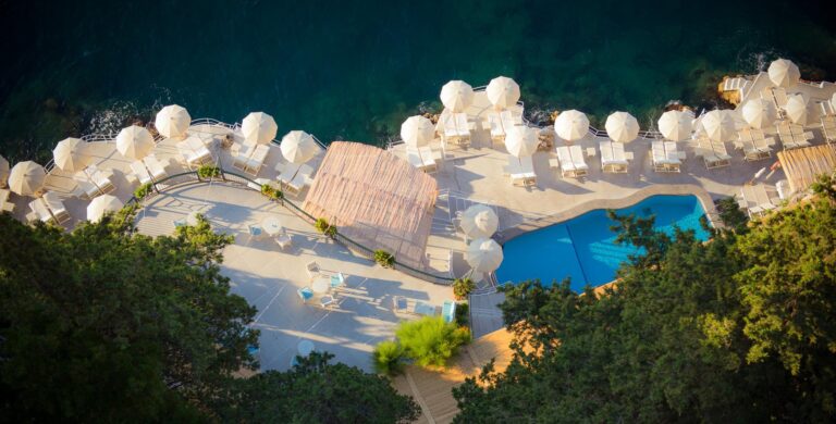 Aerial view of the beach club with its umbrellas and pool, Hotel Santa Caterina