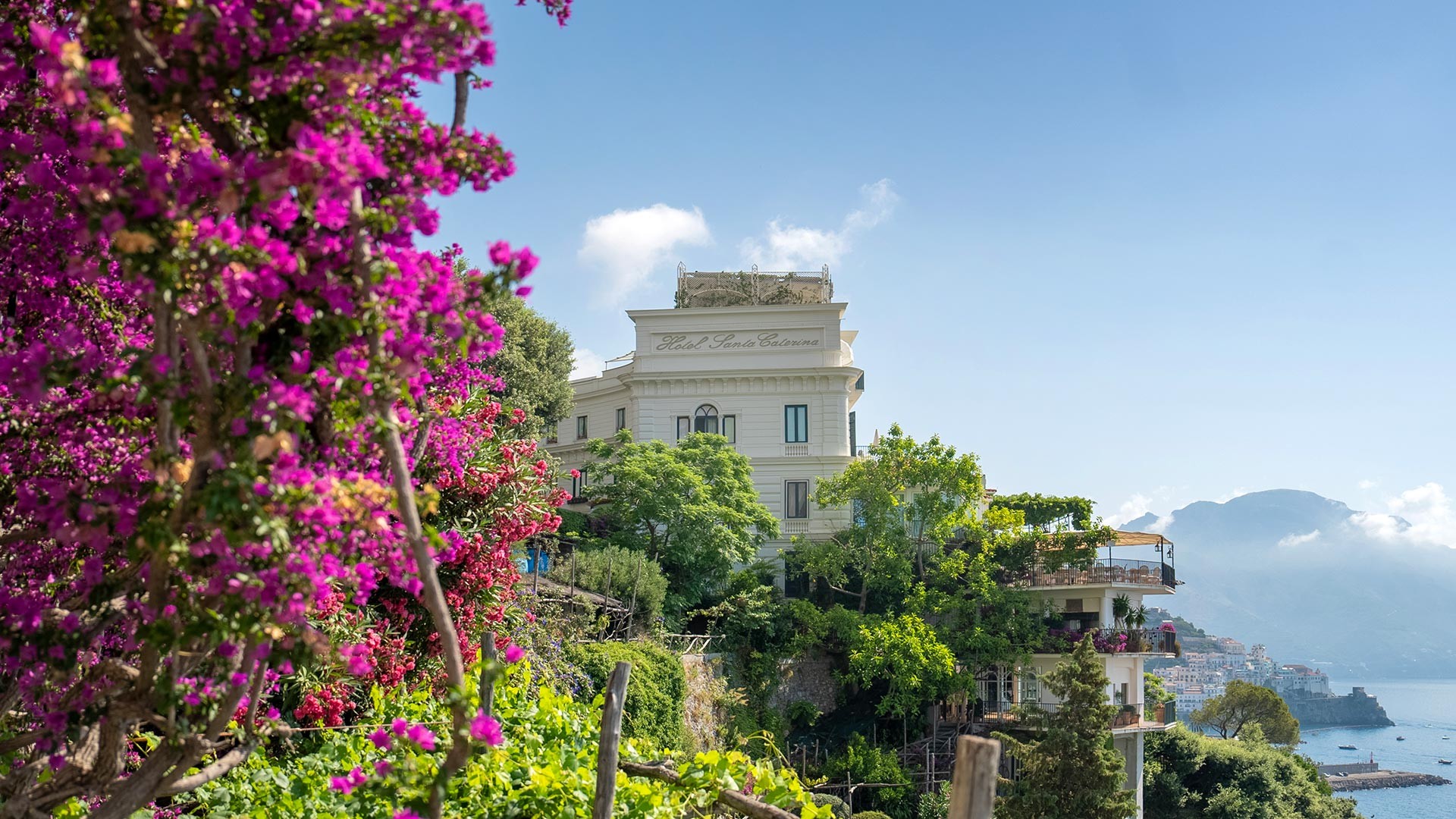 The hotel among bougainvillea with the bay of Amalfi behind, Hotel Santa Caterina