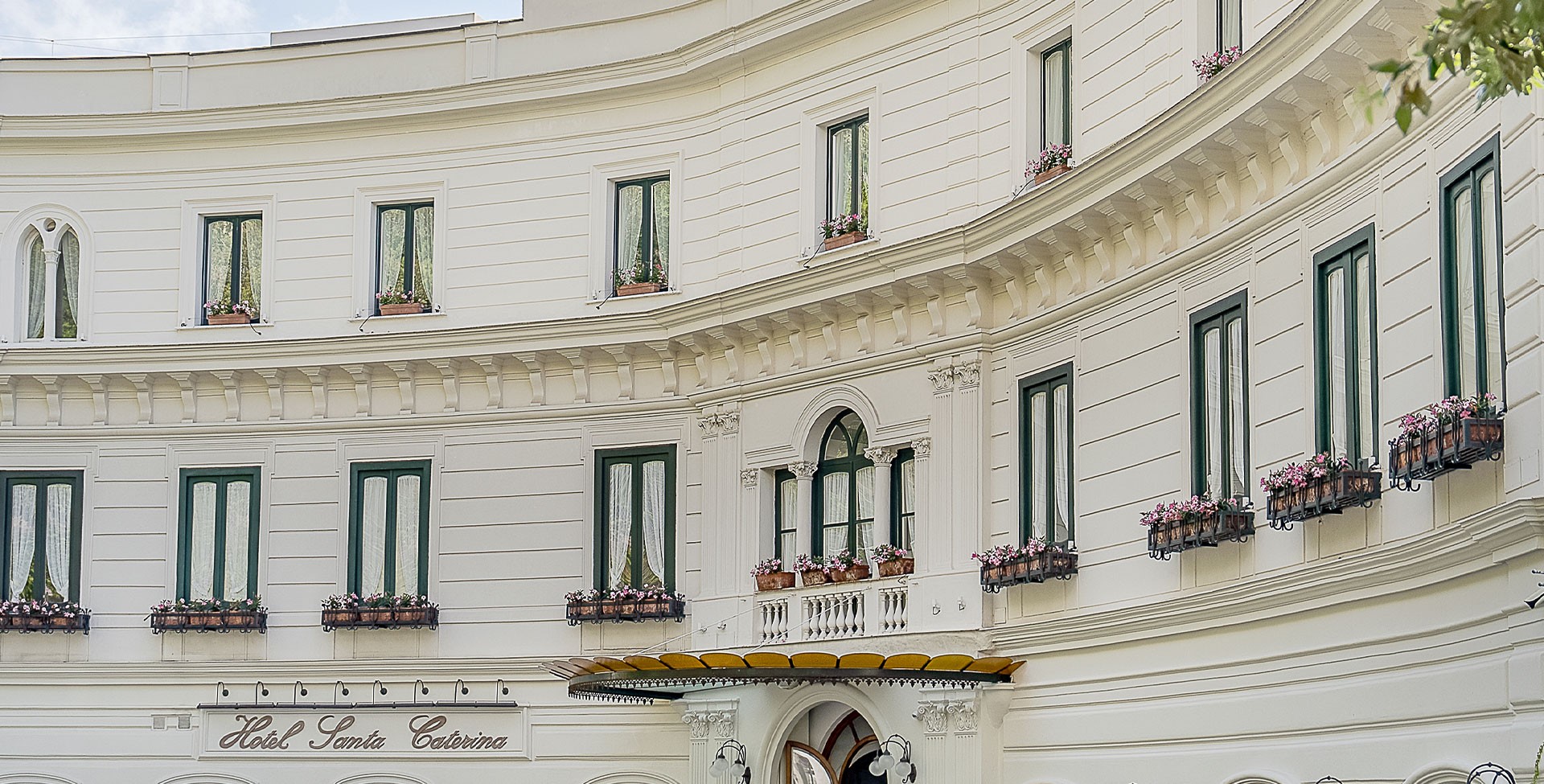 The curved white facade of the hotel, Hotel Santa Caterina