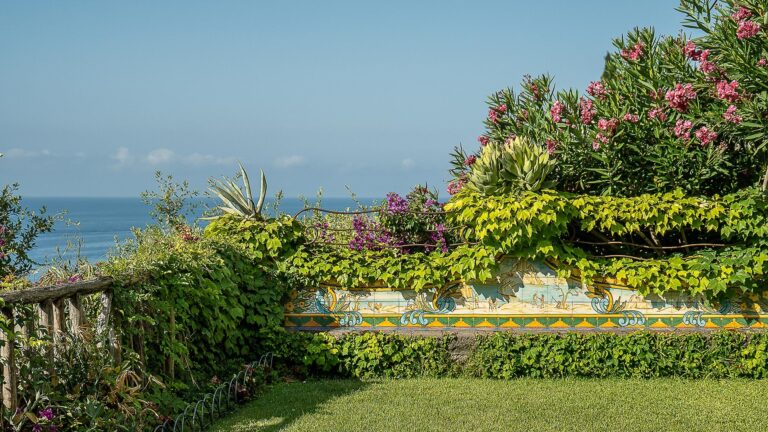 A lawn terrace above the sea with flowering shrubs, Hotel Santa Caterina