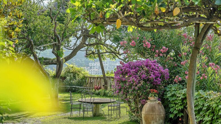 A lemon pergola and a garden table above the water, Hotel Santa Caterina