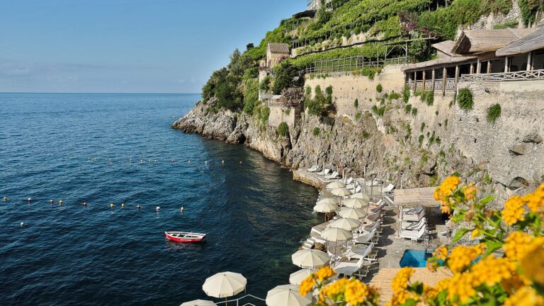 The cliffside below the hotel with the beach club on the rocks, Hotel Santa Caterina