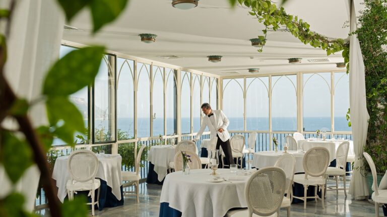 The glass-walled dining room above the sea, Hotel Santa Caterina