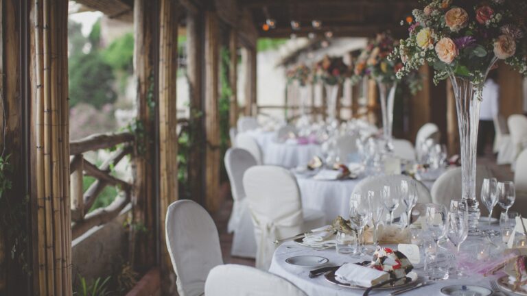 A reception table set under a flowered pergola, Hotel Santa Caterina
