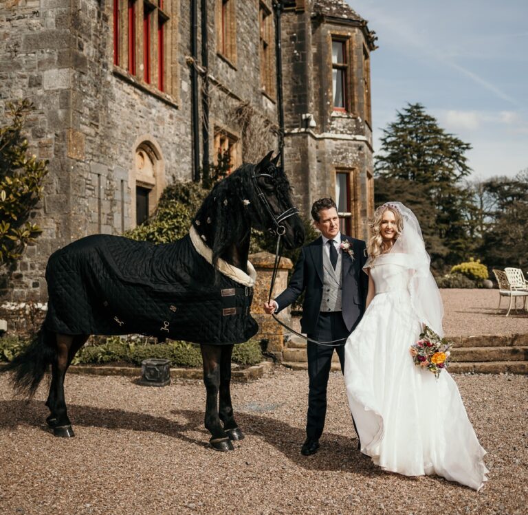 A couple on the gravel before the house, Huntsham Court