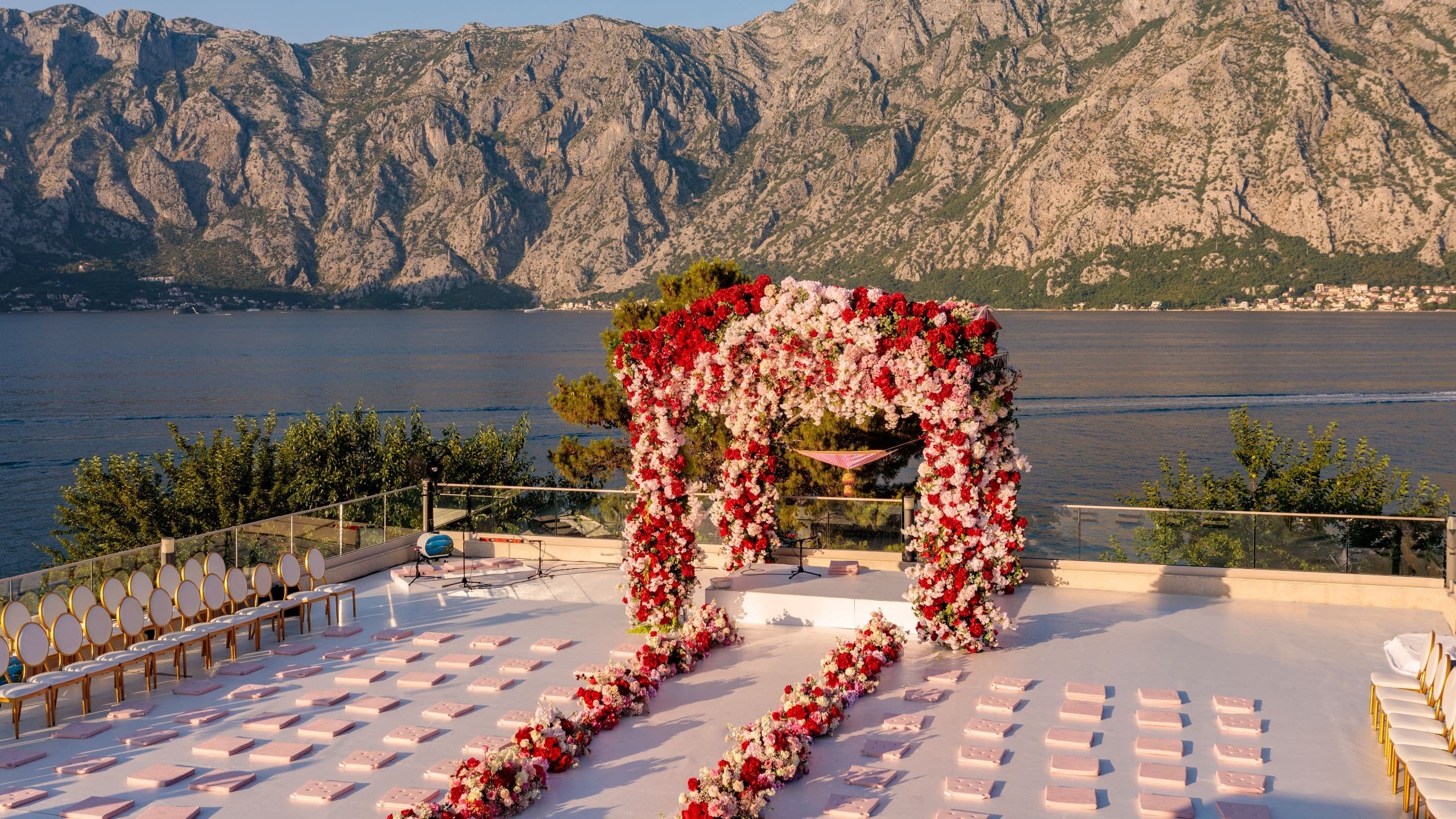A floral aisle and arch on the rooftop with the bay beyond, Hyatt Regency Kotor Bay Resort