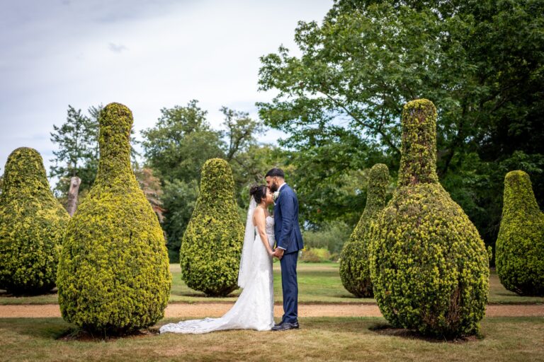 The couple among clipped topiary in the formal gardens, Hylands Estate