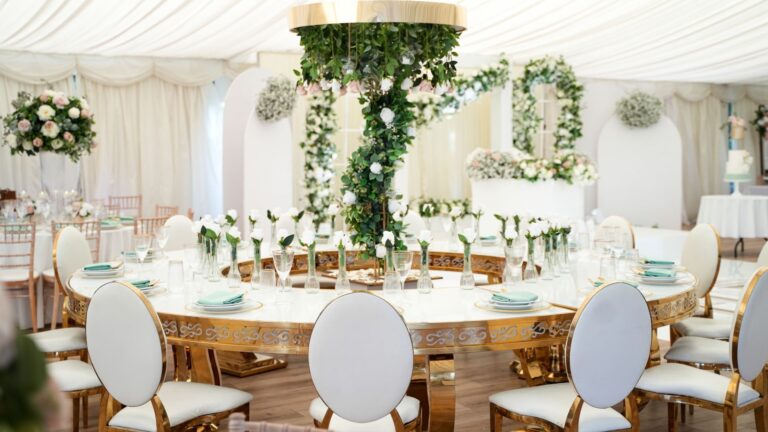 The Grand Pavilion dressed with a suspended foliage installation over round tables, Hylands Estate