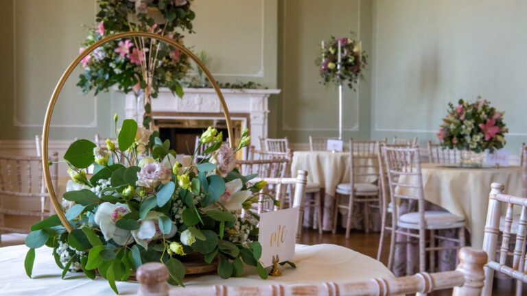 The Terrace Room, a floral hoop above the marble fireplace, tables set for dining, Hylands Estate