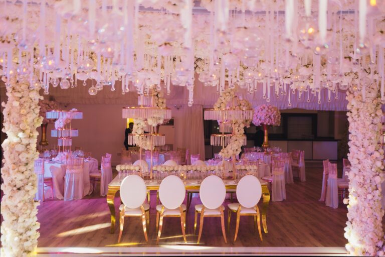 The Grand Pavilion in blush uplighting, a hanging floral canopy above the top table, Hylands Estate