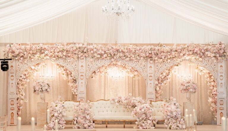 A blush and ivory mandap stage in the Grand Pavilion beneath the chandelier, Hylands Estate