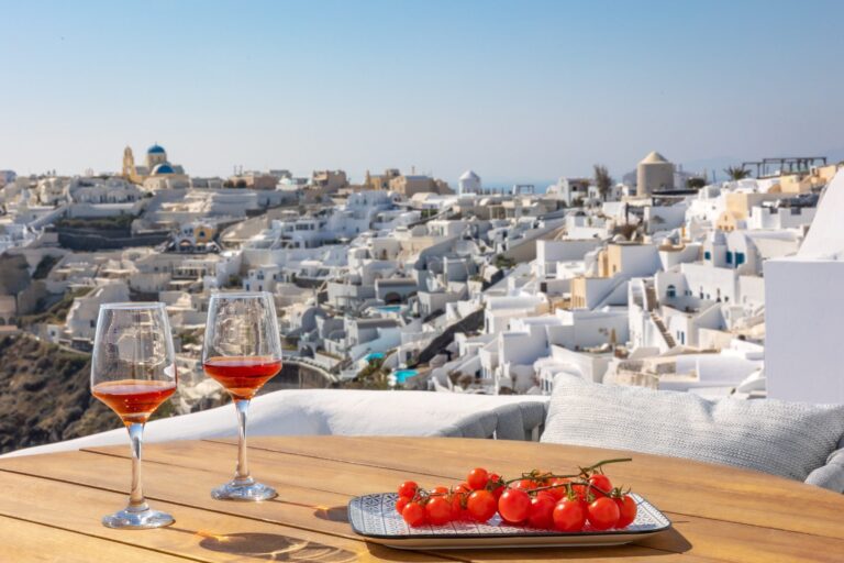 Rose wine and tomatoes on a terrace table above Oia, Ikies Traditional Houses