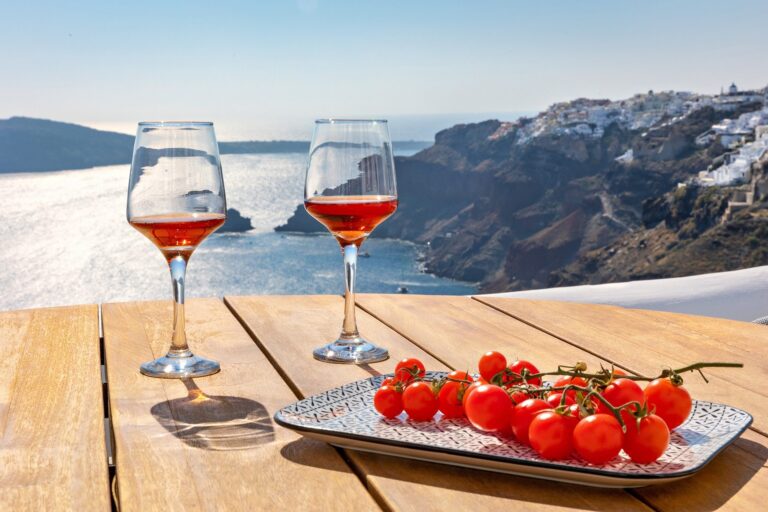Rose wine and tomatoes on a terrace table with a caldera view, Ikies Traditional Houses