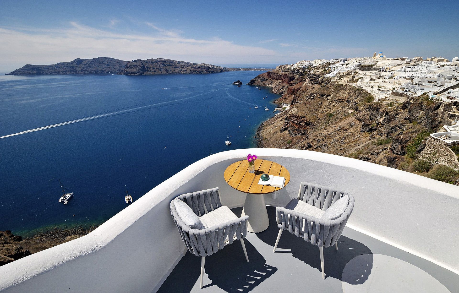 A terrace table with a view across the caldera, Ikies Traditional Houses