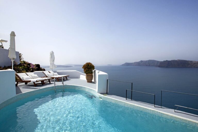 The pool above the caldera with sun loungers, Ikies Traditional Houses