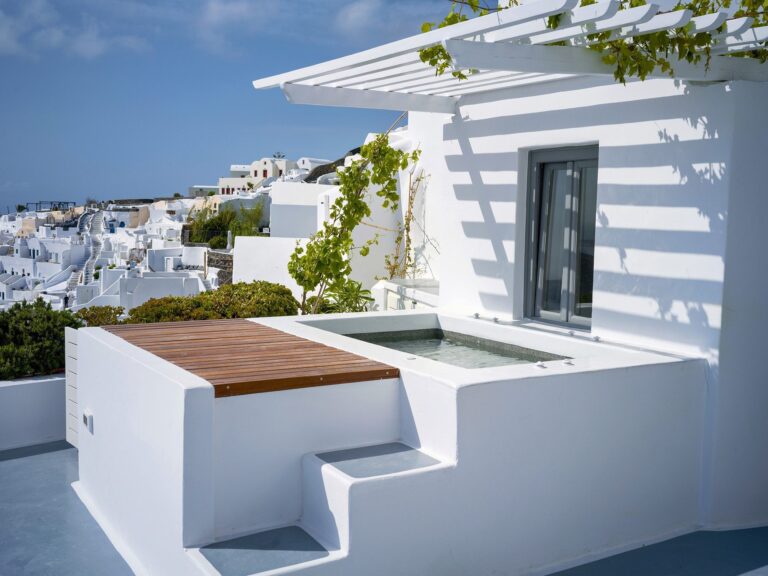 A terrace hot tub with a timber deck above Oia, Ikies Traditional Houses