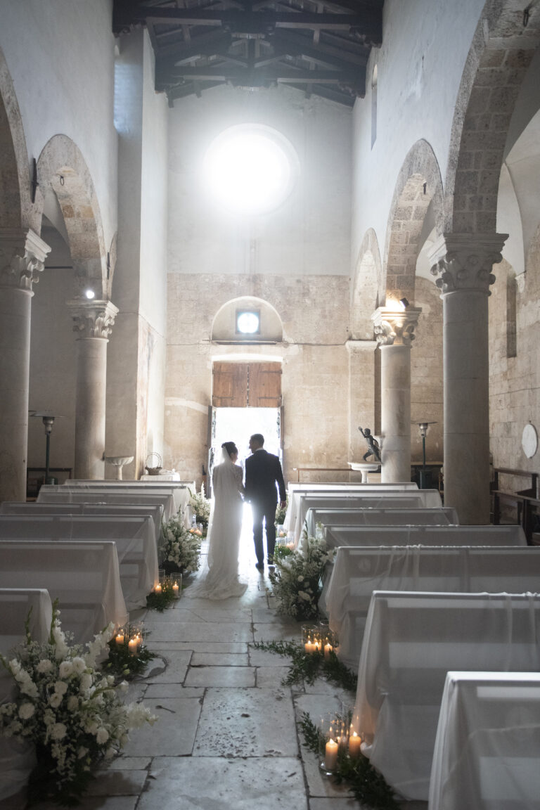 The newly married couple walking out down the nave towards the open door, Il Giorno Perfetto di Glenda Marradi