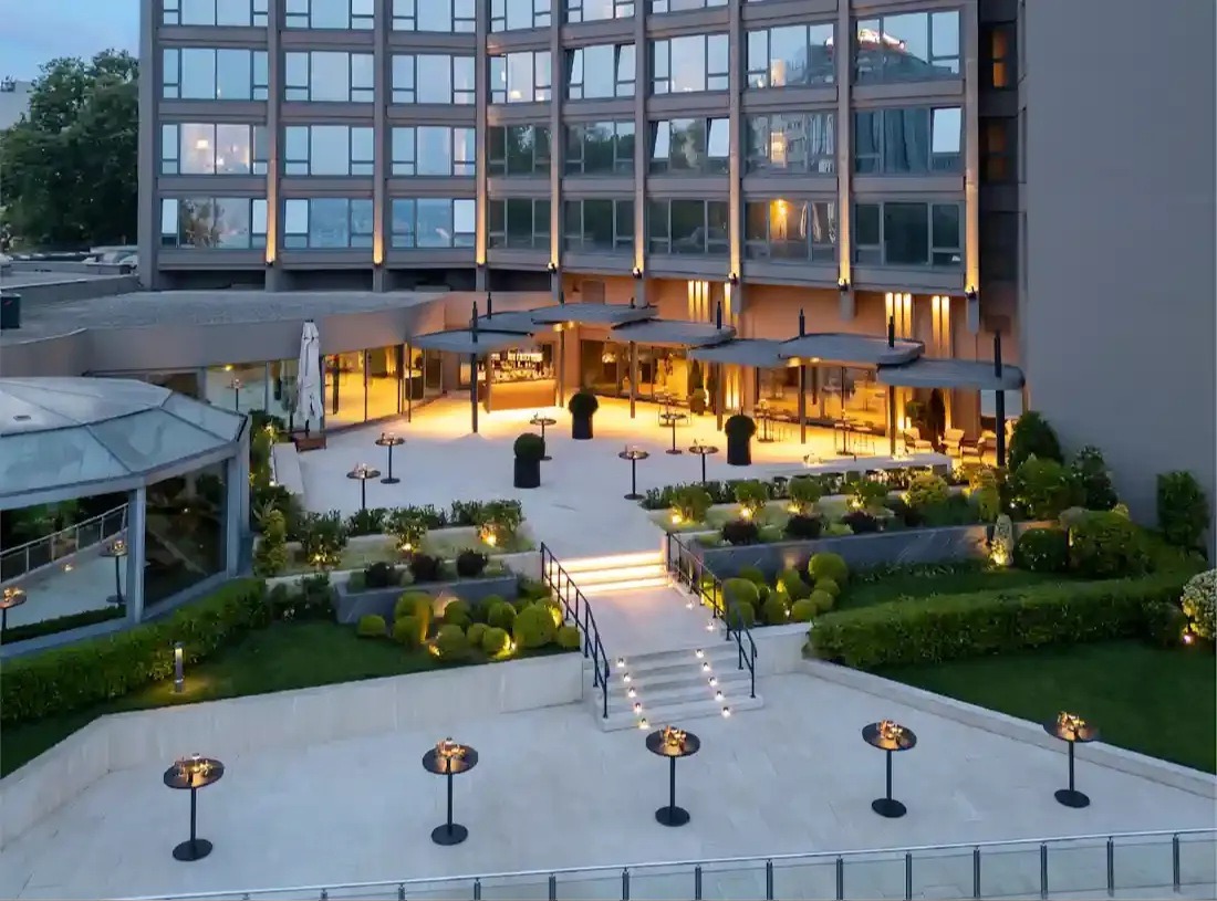The hotel building and its garden terrace at dusk, InterContinental Istanbul