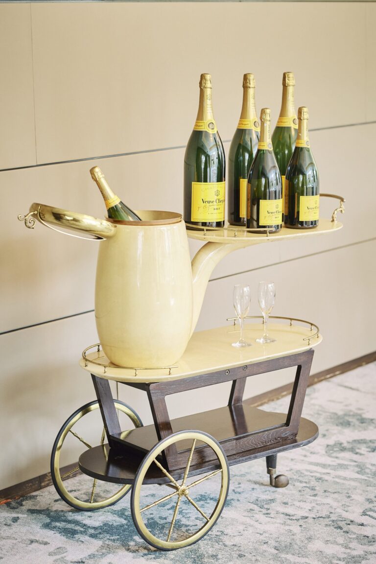 A yellow champagne trolley loaded with Veuve Clicquot bottles, used for sabrage and toasts, InterContinental London Park Lane