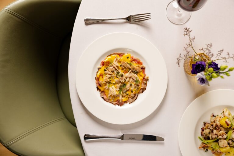 A plated pasta dish and side at a table in Theo Randall Cucina Italiana, InterContinental London Park Lane