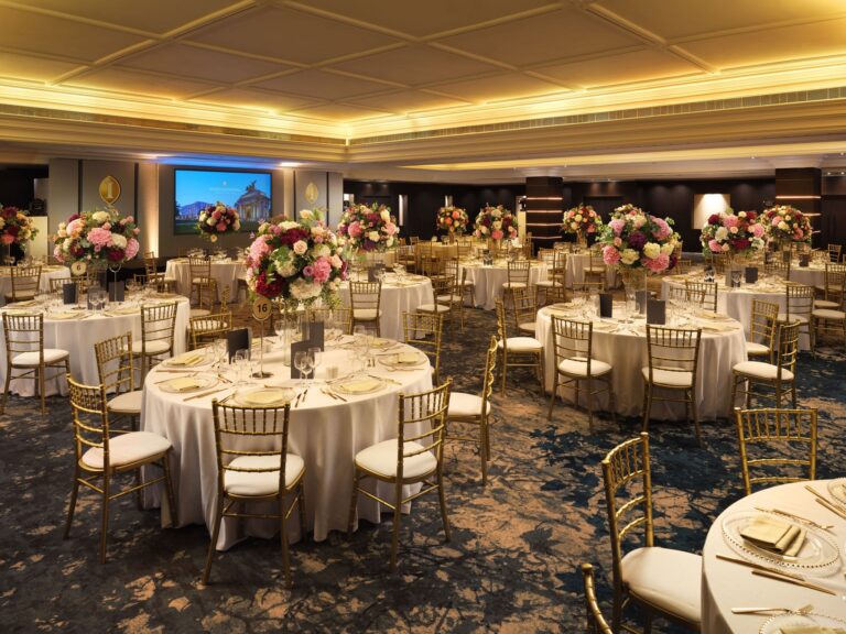 The Ballroom laid for a dinner dance with round tables, gold chiavari chairs and pink floral centrepieces, InterContinental London Park Lane
