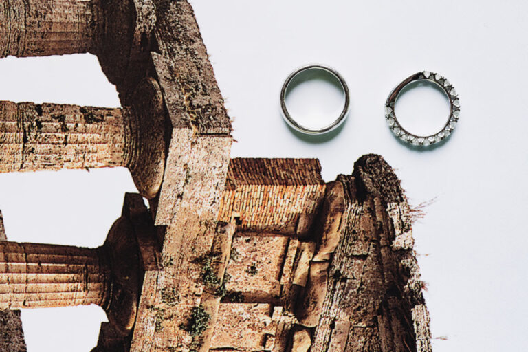 The wedding rings laid on a printed image of ancient temple columns, Iole Criscitiello