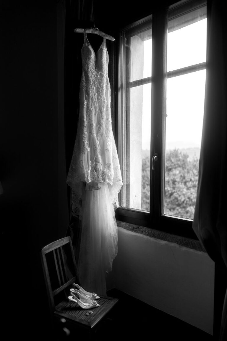 The dress hanging at an open window on the wedding morning, Iole Criscitiello