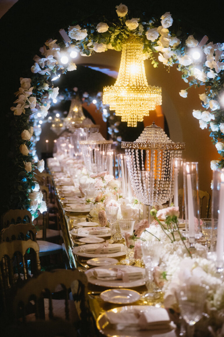 Dinner at Domus Laeta on the Cilento coast, chandeliers hung inside a rose and hydrangea arch, Iole Criscitiello