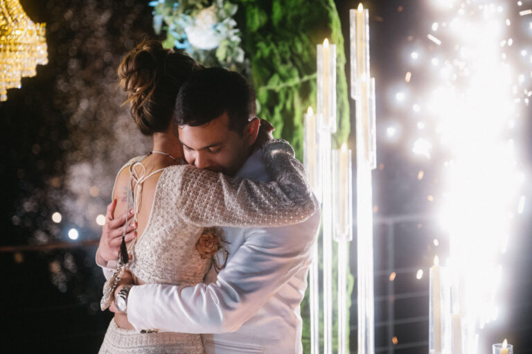 An embrace on the dance floor, sparklers still burning, Iole Criscitiello