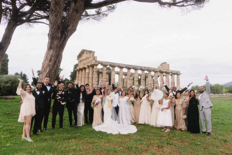 The whole wedding party on the lawn in front of a Greek temple at Paestum, Iole Criscitiello