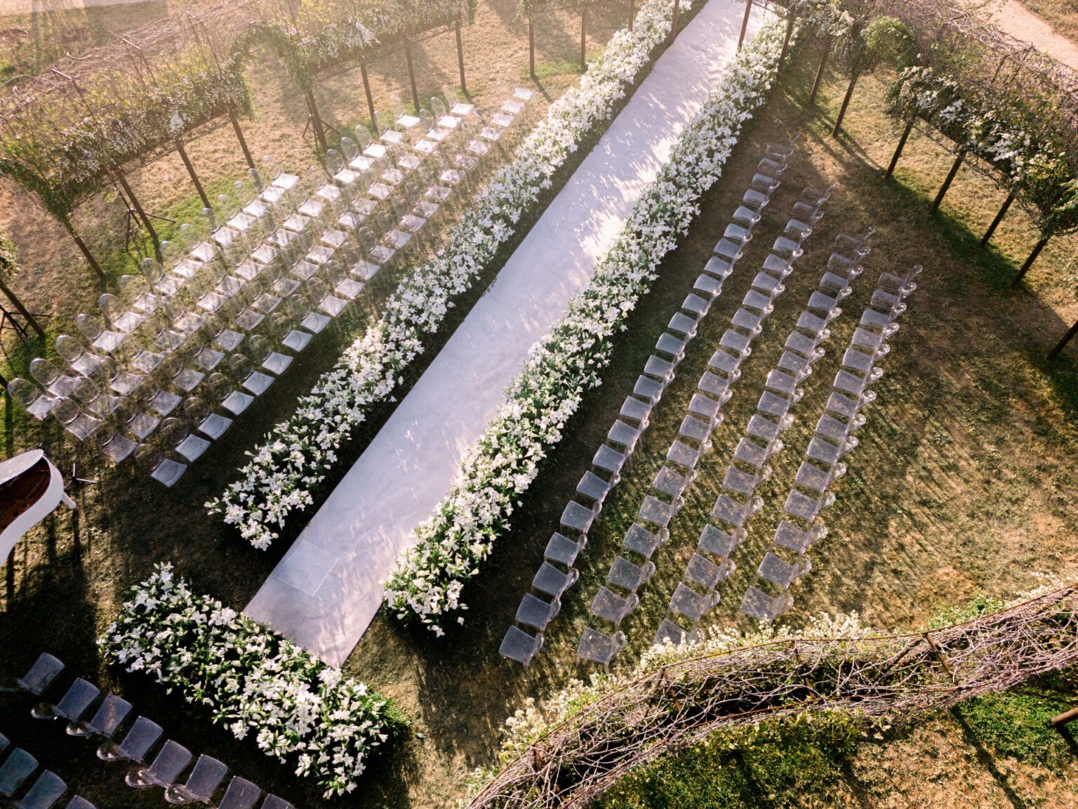Aerial view of ceremony seating with a floral aisle, Iris Orangerie