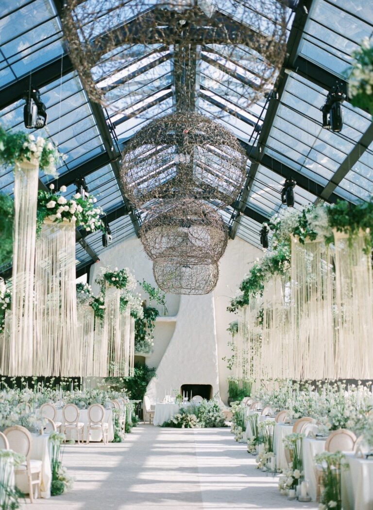 Glasshouse aisle with hanging floral installations, Iris Orangerie