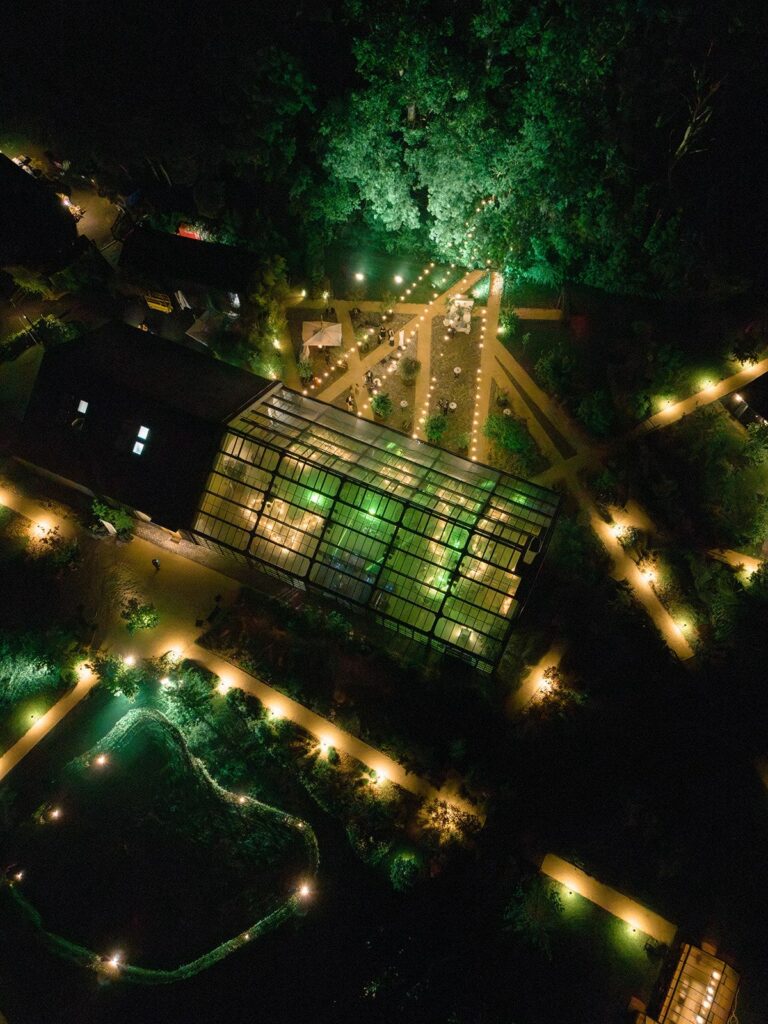 The estate lit at night from above, Iris Orangerie
