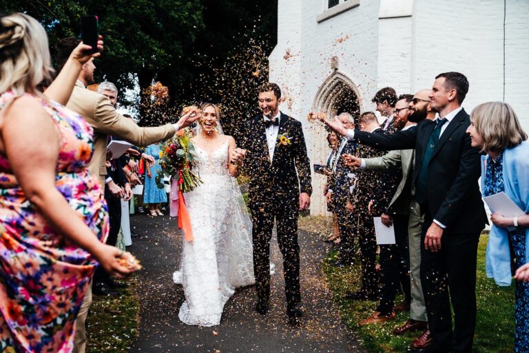 Confetti thrown over the couple as they leave the church on the edge of the estate, Iscoyd Park