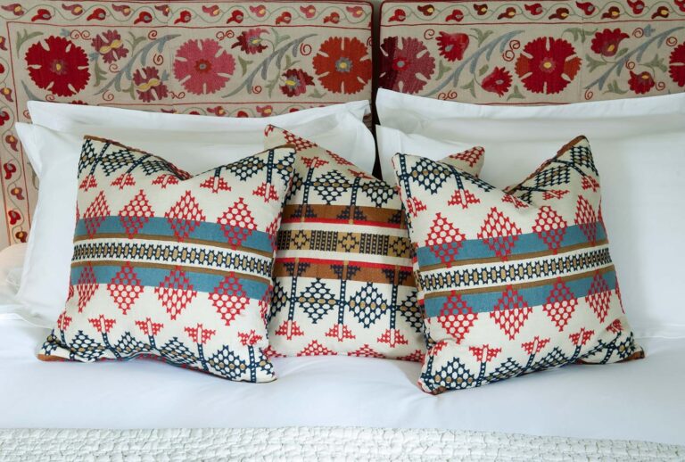 Layered bedding and patterned cushions in one of the fifteen individually styled bedrooms, Iscoyd Park